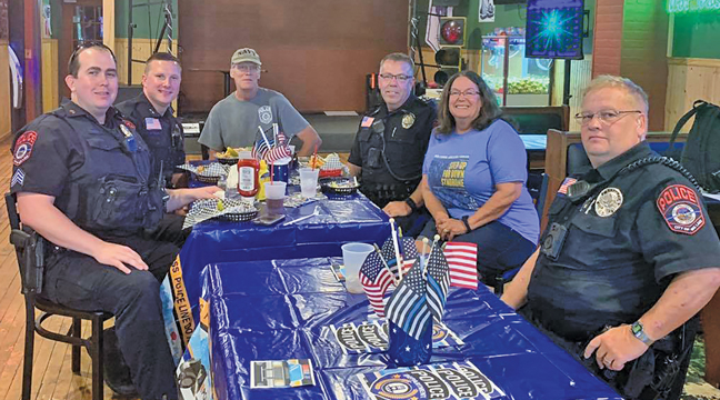 A HANDFUL OF BIG LAKE POLICE OFFICERS were able to enjoy a meal at Third Rail Bar & Restaurant including Tom Kucala, Matt Hayen, Joel Scharf and Todd Siebert (left to right).  Joining the BLPD were George Quinn (far back) and Commissioner Raeanne Danielowski (second from right). (Submitted Photo).