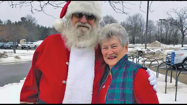 HERE COMES SANTA CLAUS! Top photo: Santa told Elaine Chmielewski she appeared on his nice list when she attended Christmas Day Dinner at Becker Community Center. (Submitted photo).