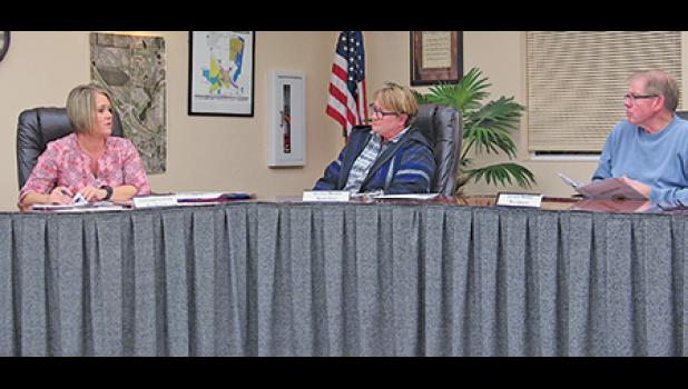 Clear Lake Supervisors Sandy Paige and Bob Arnold listen while Clerk Kari Mechtel explains that an individual has expressed interest in purchasing a city property. (Photo by Penny Leuthard)