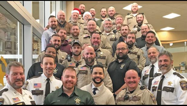 WRIGHT CO. SHERIFF SEAN DERINGER (front row, far right) with some of the employees who took part in the Wright Co. Sheriff’s Office Beard Challenge. (Online Photo)