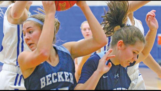 COURTNEY NUEST (#15) pulls down a rebound as Maren Westin (#12) pulls away from the Foley attackers.
