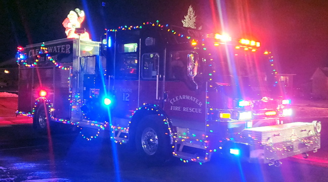  SANTA WAVES AT ONLOOKERS as he parades through Clearwater on Sunday. (Submitted photo.)