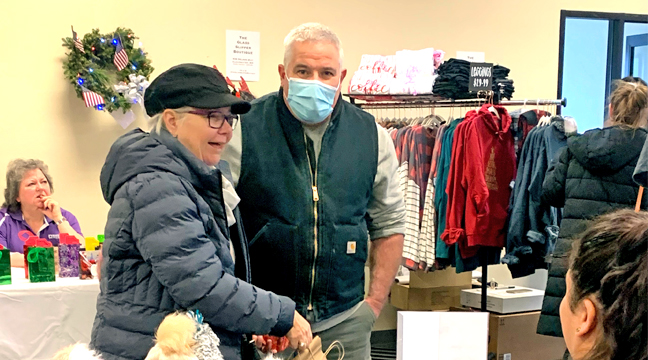 CLEARWATER CHRISTMAS CENTRAL attendees look over a selection of brightly colored hats and scarves last Saturday. (Photo by Penny Leuthard.)