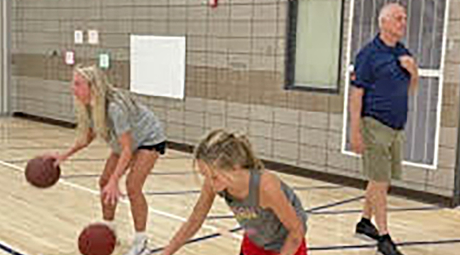Adeline Kent (L) and Coach Scott Gudmundson presided over a drill at the Becker lady Bulldogs summer basketball camps. (Submitted photo.)