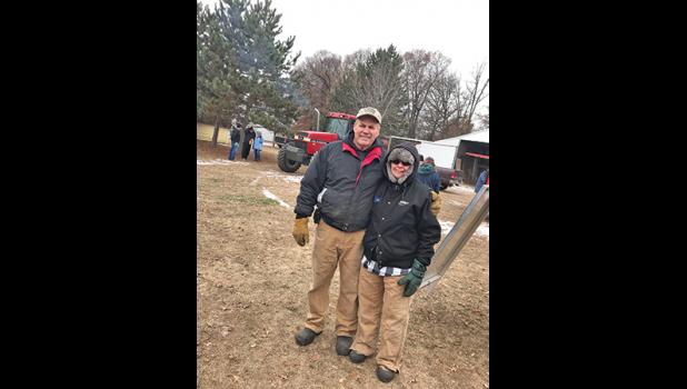 OUTDOOR AUCTION SALE. Rick and Bonnie Olson of Becker are pictured at their farm near Becker at their retirement auction last week. The weather was cold, but it did not deter droves of people from making it out to the sale. The sale was well attended according to auctioneer Al Wessel of Mid American Auction Co. (Submitted Photos).