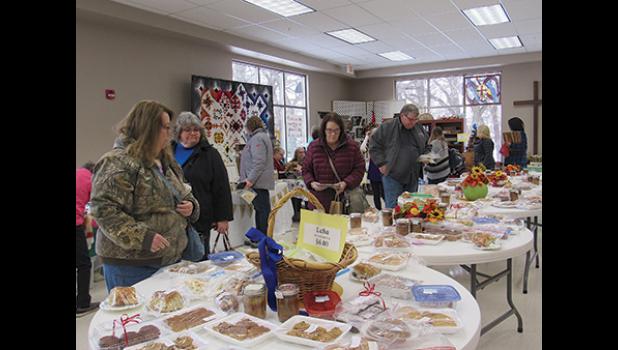 TABLES FULL OF HOMEMADE GOODIES were a popular area during Faith Lutheran’s fall craft and bake sale in Becker last Saturday, with lefse being a purchase favorite. (Photo by Penny Leuthard)