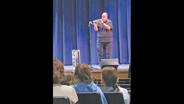 SPEAKER REGGIE DABBS gets Becker high school students enthusiastically singing along to popular songs with the accompaniment of his saxophone. (Photo by Penny Leuthard).