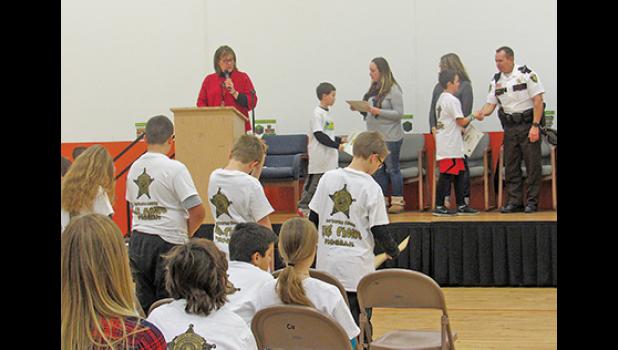 CLEARVIEW FIFTH-GRADERS receive their certificates of completion during the school’s KIDS Choice graduation last week. (Photo by Penny Leuthard)
