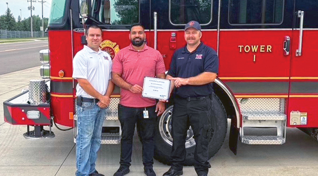 CenterPoint Energy Supervisor, Home Service Plus, Mustafa Hamdani presents a Community Safety Grant to Captain Nick Christenson and Deputy Chief Jeff Novak, Big Lake Fire Department. (Submitted Photo).