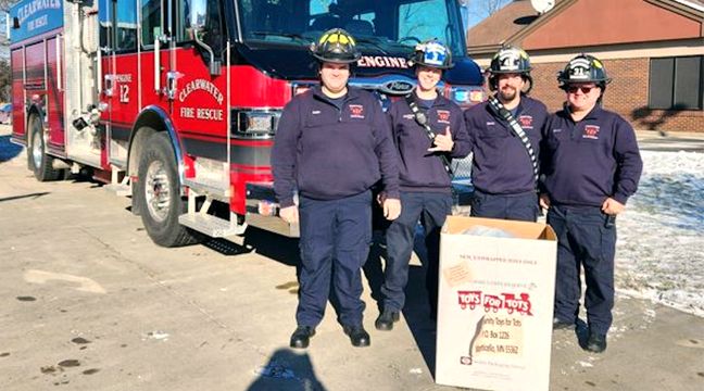 MEMBERS OF THE CLEARWATER FIRE DEPT. stopped by to help some of the businesses participating in the Clear Valley Community Toys for Tots event. (Submitted photo.)