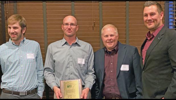 Assistant Superintendent Jason Henderson held the plaque while (L to R) Head Golf Superintendent Jason Scharfencamp, General Manager Josh Kuha and Golf Services Manager Ian Holmes posed for a photo during Monday’s MGA meeting at Brackett’s Crossing Country Club. (Submitted Photo)