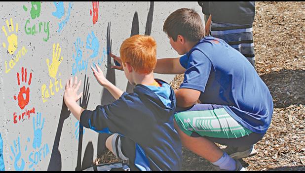 Kids from Clearview Elementary School helped decorate a wall with hand prints at Spring Street Park in Clearwater this summer.