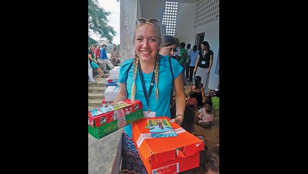 ADAIR FRIEDMAN of Becker was thrilled to be able to first-hand hand-out shoeboxes to Madagascar children as part of the Samaritan’s Purse Operation Christmas Child program last year. (Citizen-Tribune Archive Photo).