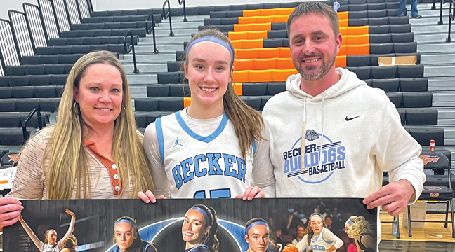 Lexi Rose   took time after Tuesday’s game to celebrate with her parents after achieving 1,000 career points. (Submitted Photo).