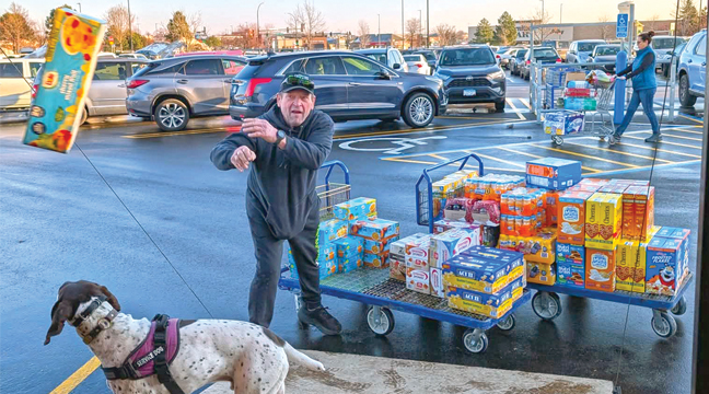MIKE GARLAND (and best friend) helped to load the delivery truck after he and his crew accumulated over $3,600 worth of food. (Submitted Photo).