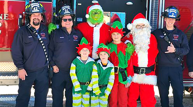 AFTER THE KIDS CHRISTMAS PARTY ended at the Clearwater Legion, Santa Claus, the Grinch, and three elves joined members of the Clearwater Fire Dept. to help draw attention to the community wide Toys for Tots event. (Submitted photo.)